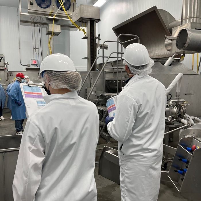 Production line review, workers in hairnets and white coats