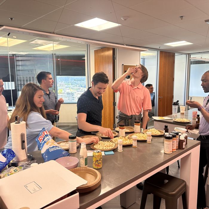 Entrepreneurs gathered around a tasting counter