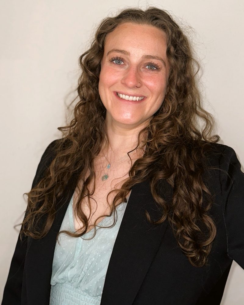 Julia Thompson, smiling, in a black blazer