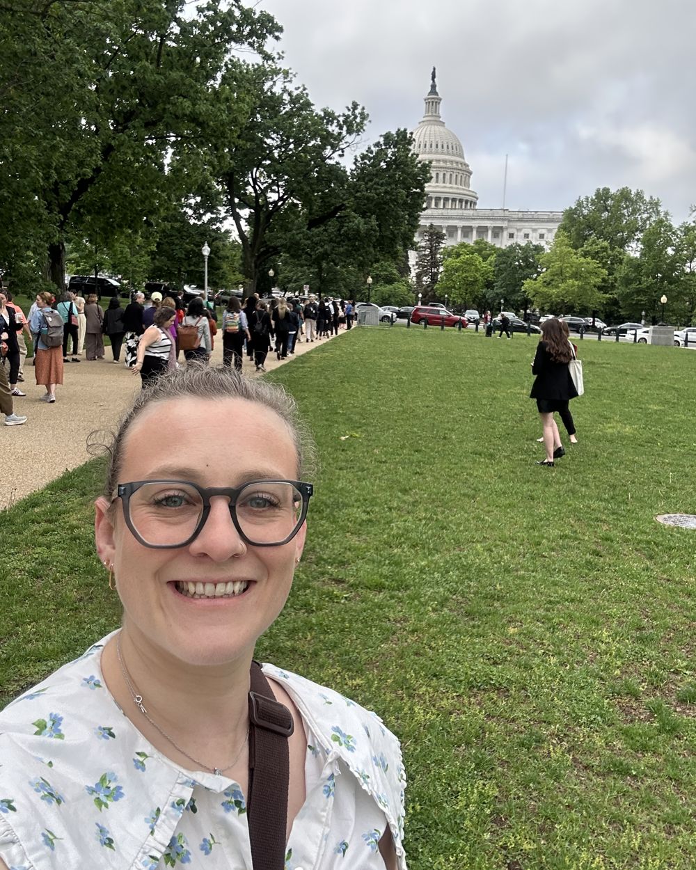 Julia smiling on the lawn in front of the U.S. Capitol dome