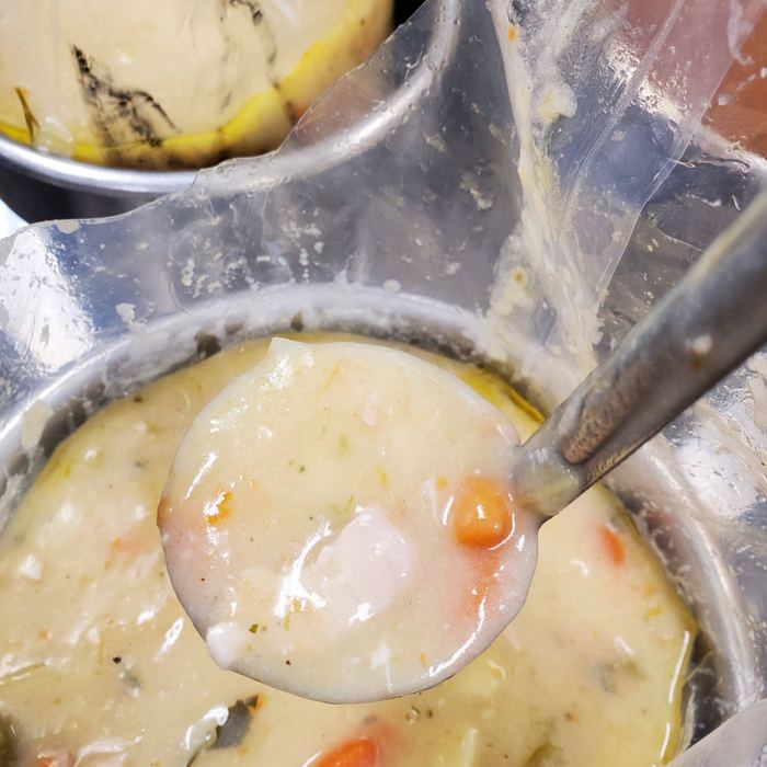 A ladle of chowder from a steam kettle